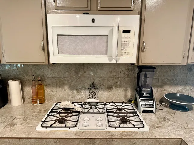 a kitchen with a stove and cabinets