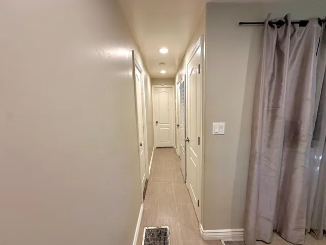 a view of a hallway with windows and closet