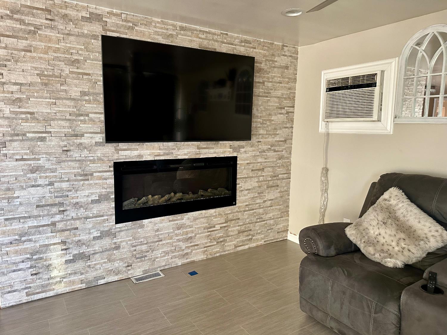 3435 Marfargoa Road, Unit 74 Stockton, CA 95215 - Photo 9 of 21 a living room with furniture and a fireplace