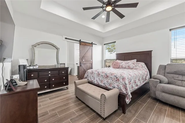 a bedroom with a bed and ceiling fan