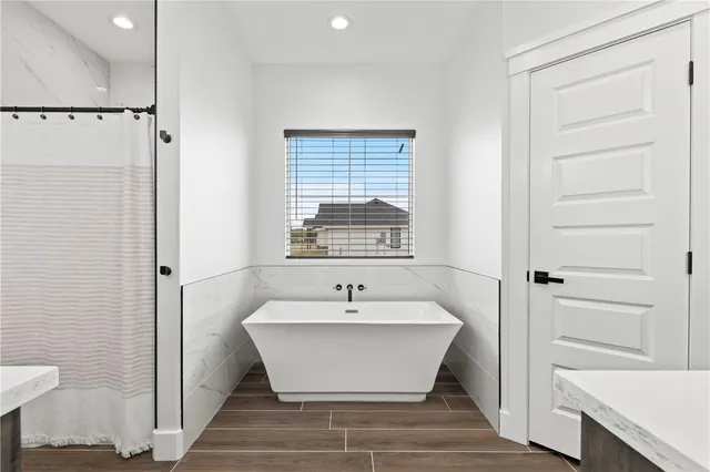 a view of a bathroom with a bathtub and shower