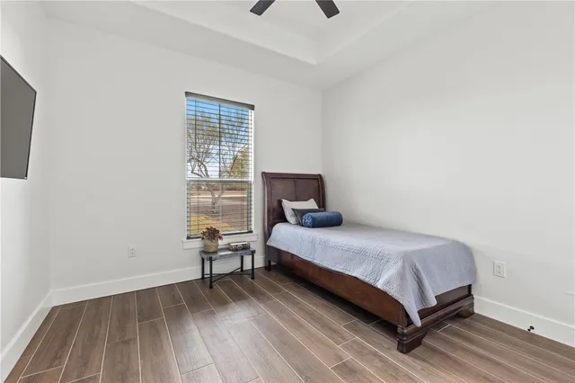 a bedroom with a bed and wooden floor