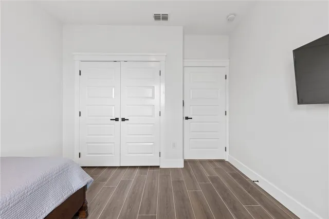 a view of a room with wooden floor