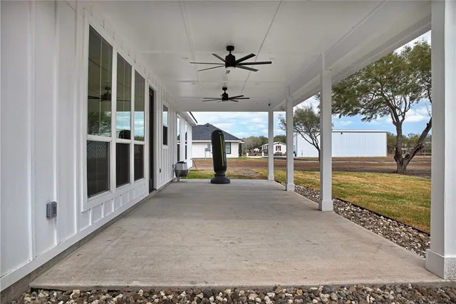 a view of a porch with furniture and a yard