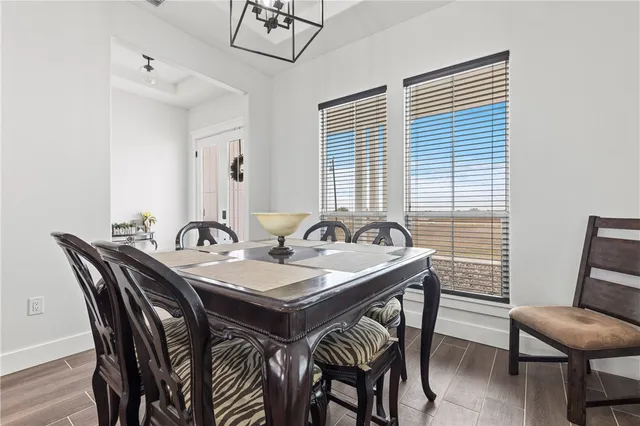 a view of a dining room that has a table and chairs