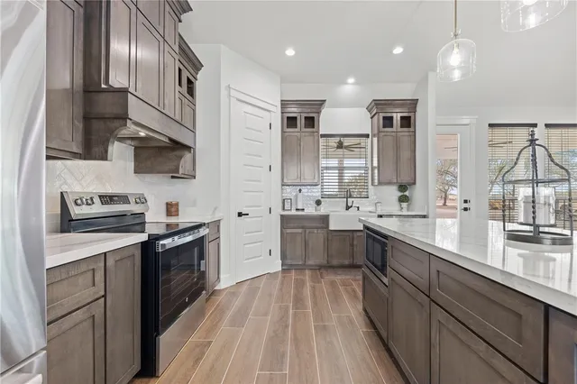 a kitchen with stainless steel appliances granite countertop lots of counter top space a sink and cabinets