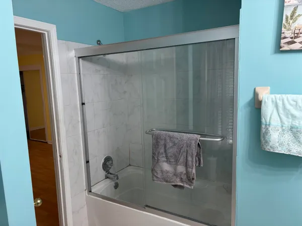 a bathroom with a shower and a sink