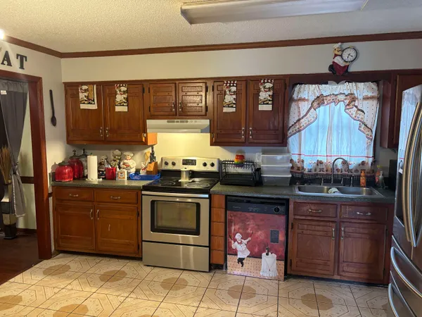 a kitchen with stainless steel appliances granite countertop a stove and cabinets