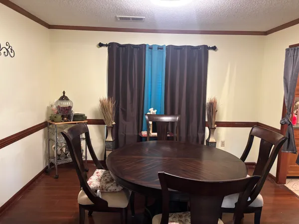 a view of a dining room with furniture and wooden floor