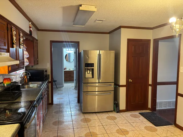 a kitchen with stainless steel appliances a refrigerator and a stove top oven