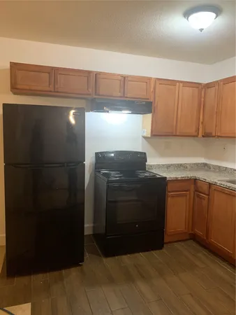 a kitchen with a sink and a refrigerator