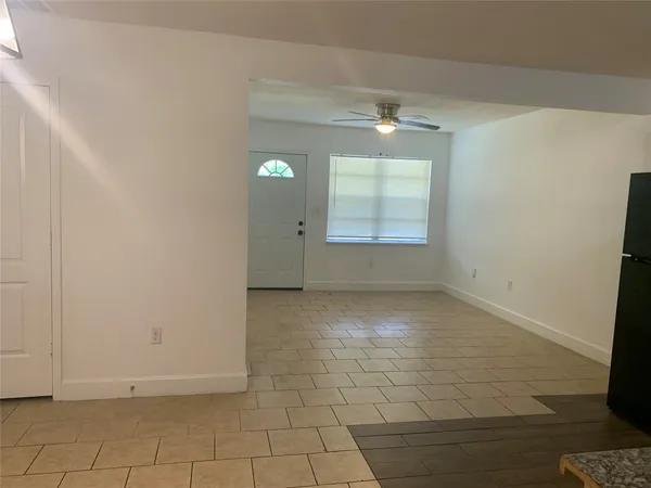 an empty room with windows and entrance
