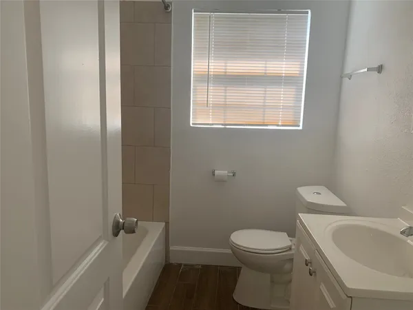 a bathroom with a toilet a sink and bathtub