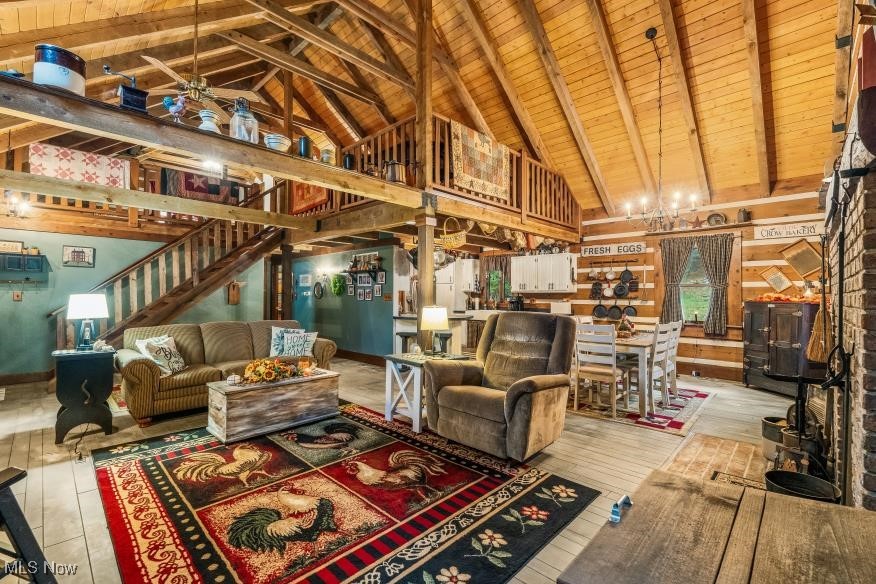 128 Stanley Mills Road Little Hocking, OH 45742 - Photo 12 of 44 Living room featuring wood walls, light hardwood / wood-style flooring, lofted ceiling with beams, and wooden ceiling