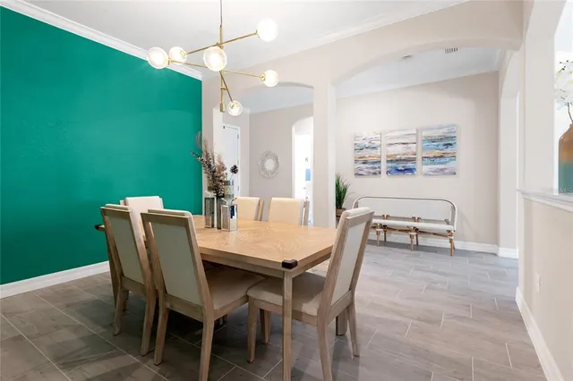 a bedroom with a bed and painting on the wall