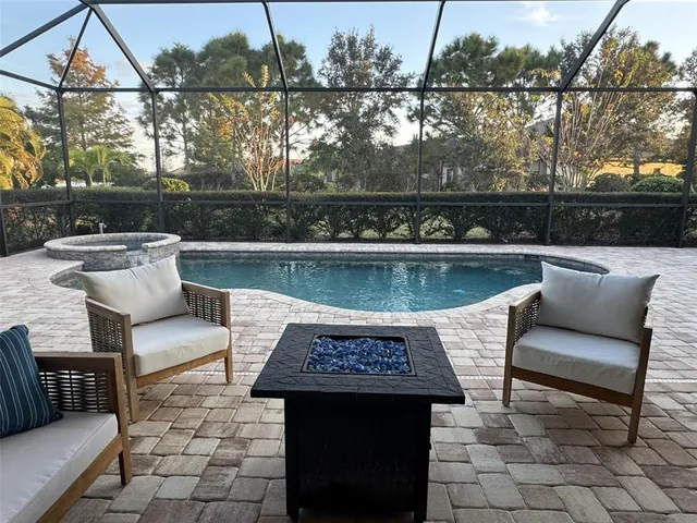 swimming pool view with a seating space and tv