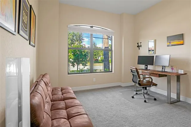 a view of a patio with a table and chairs under an umbrella