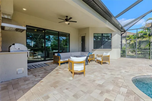 an aerial view of residential houses with outdoor space and lake view