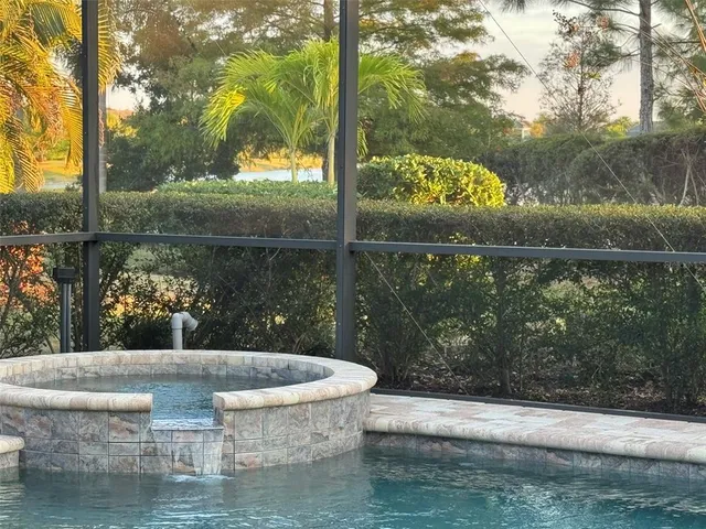 an aerial view of residential houses with outdoor space and parking