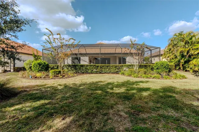 an aerial view of a house with outdoor space and lake view