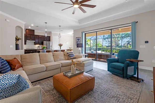 a kitchen with stainless steel appliances kitchen island granite countertop a table chairs and a refrigerator
