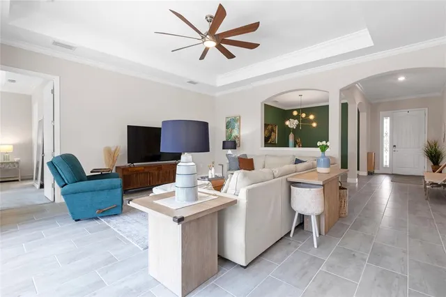 a kitchen with stainless steel appliances kitchen island granite countertop a refrigerator a stove a sink and a oven with wooden floor