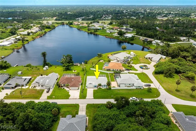 an aerial view of a house with a swimming pool yard and outdoor seating