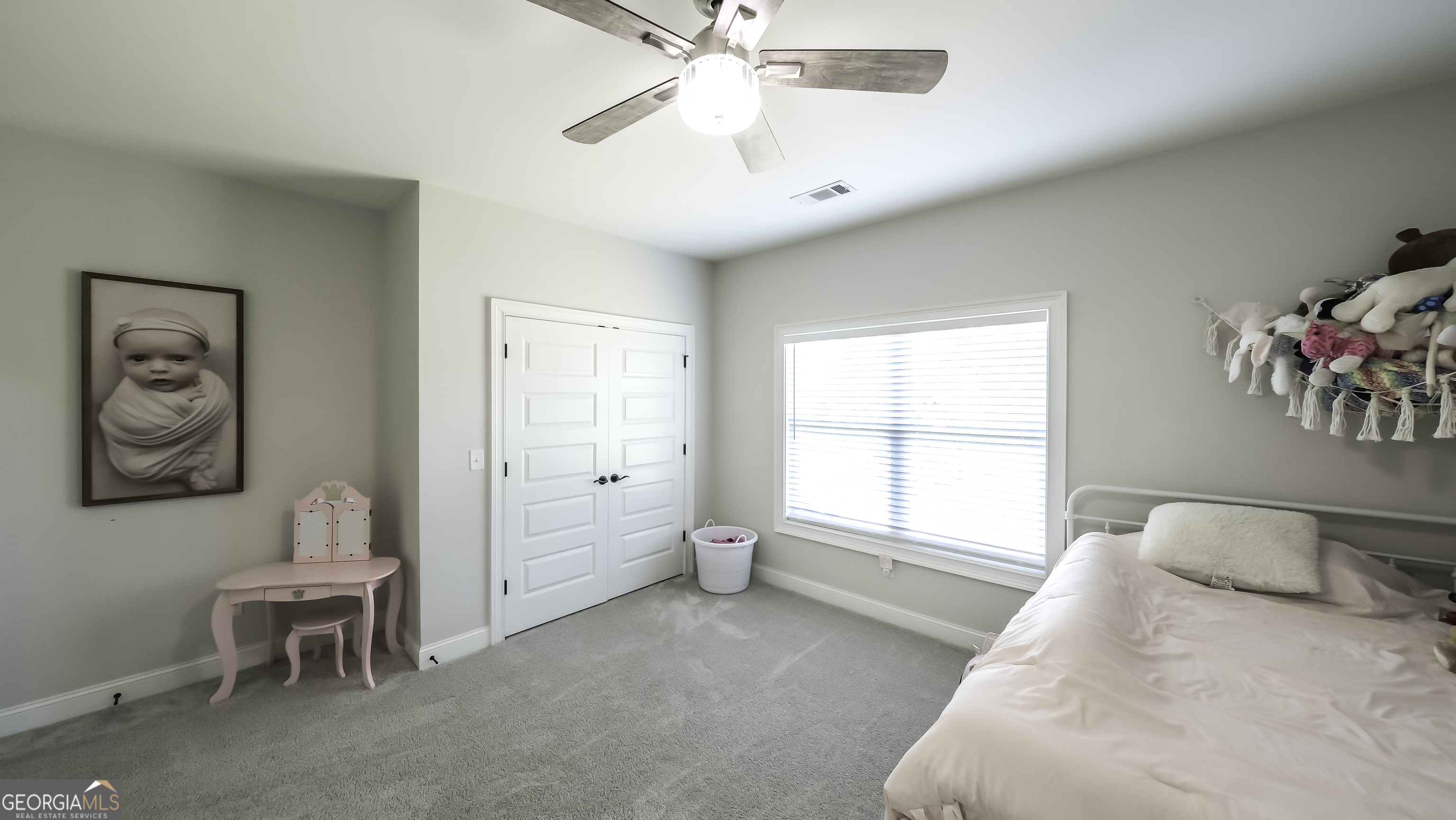 2392 Welcome Road Roopville, GA 30170 - Photo 28 of 43 a spacious bedroom with a bed and a chandelier