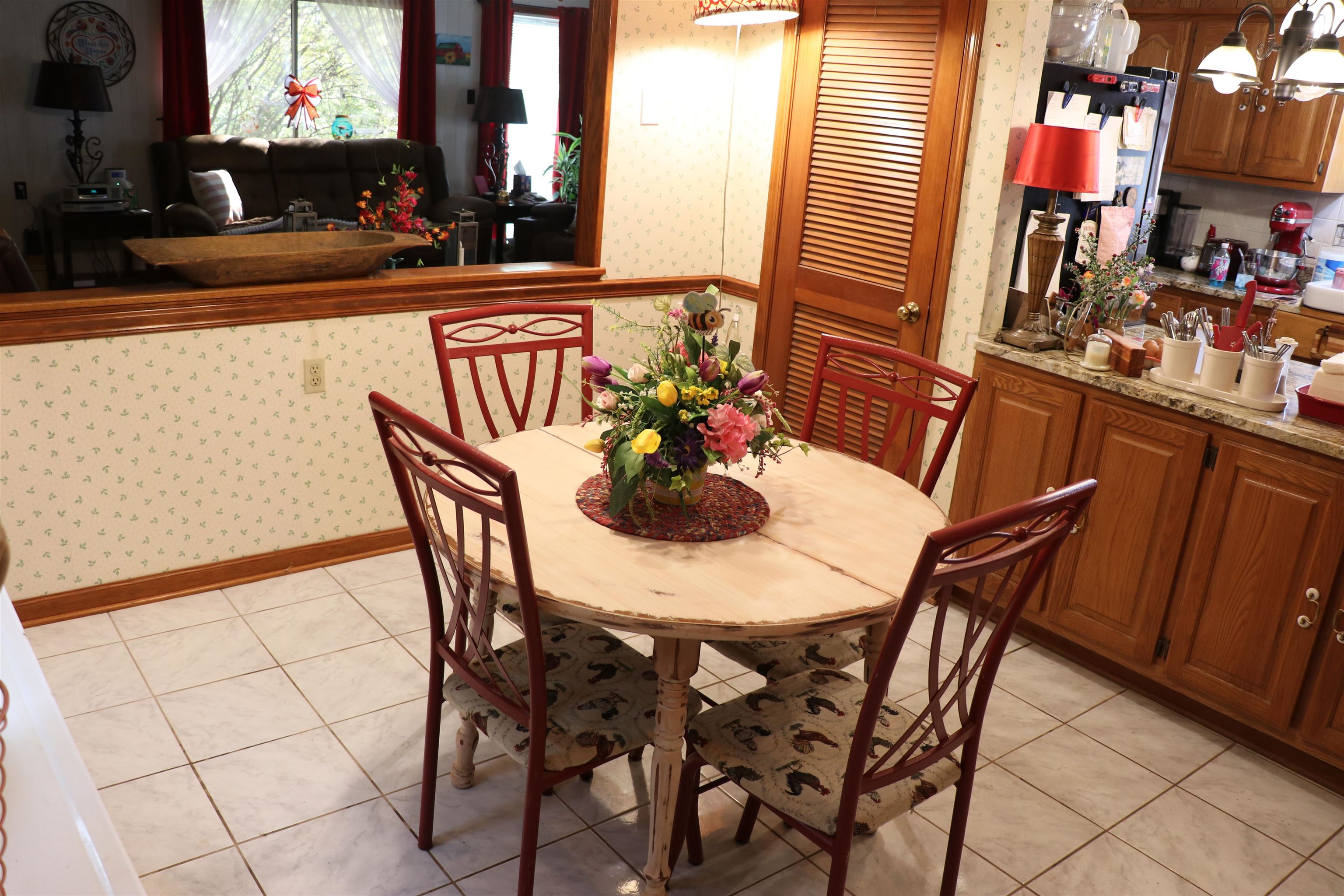 937 Kelleys Chapel Road Burlison, TN 38015 - Photo 11 of 27 Dining space with wallpapered walls, a chandelier, and light tile patterned flooring