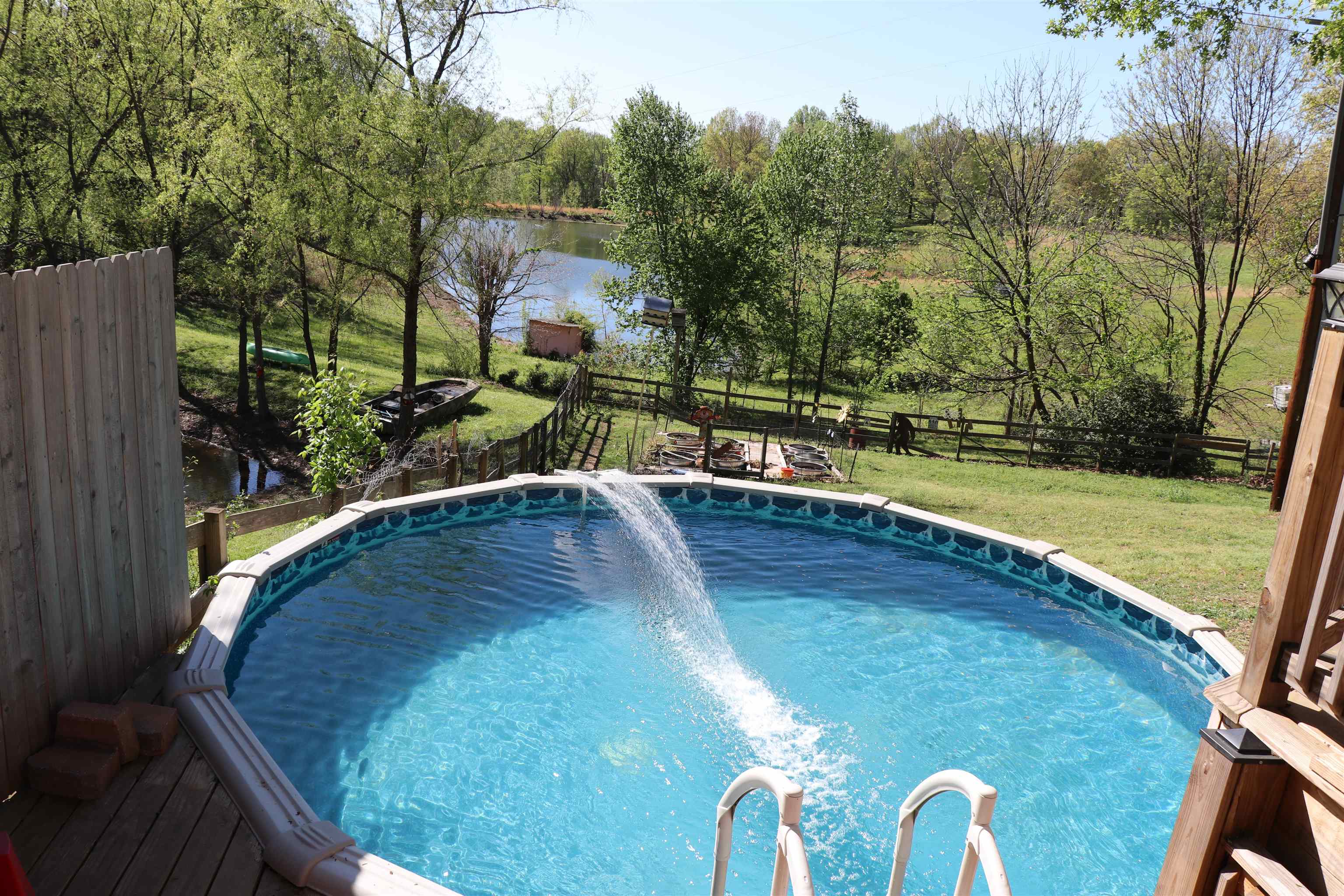937 Kelleys Chapel Road Burlison, TN 38015 - Photo 14 of 27 Outdoor pool featuring a fenced backyard and a water view