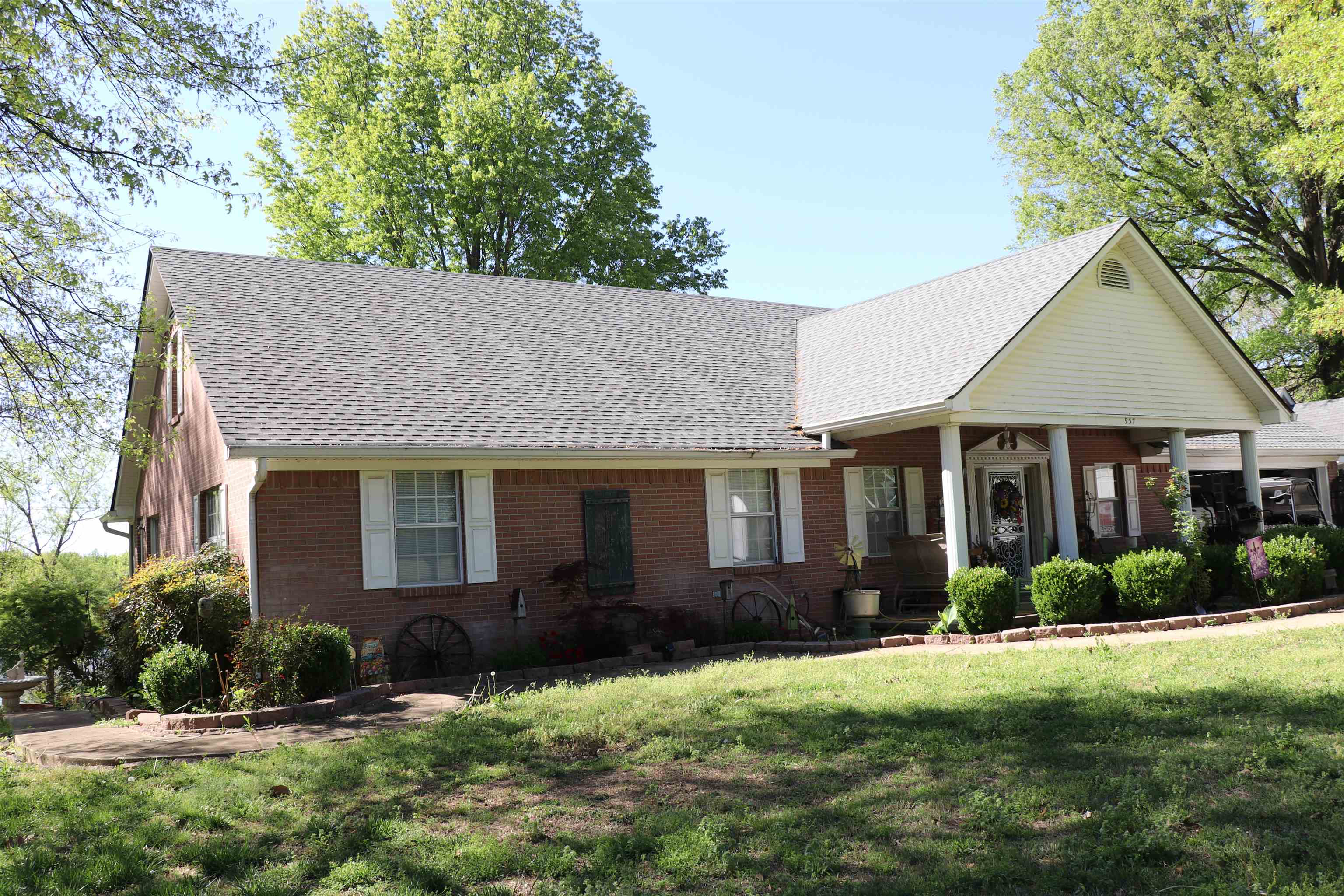 937 Kelleys Chapel Road Burlison, TN 38015 - Photo 2 of 27 View of front of home featuring a shingled roof, brick siding, a front lawn, and a porch