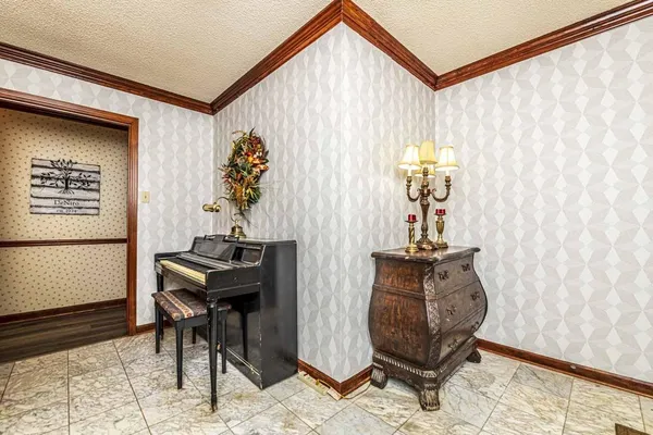 a view of a balcony with chairs potted plants with wooden floor and outdoor seating