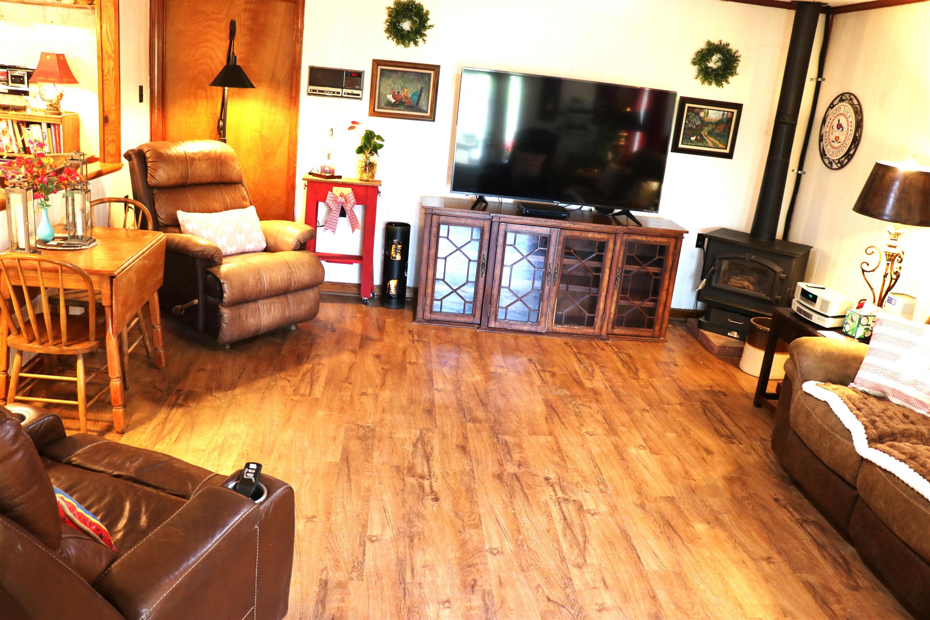 937 Kelleys Chapel Road Burlison, TN 38015 - Photo 6 of 27 Living room with light wood-style floors and a wood stove