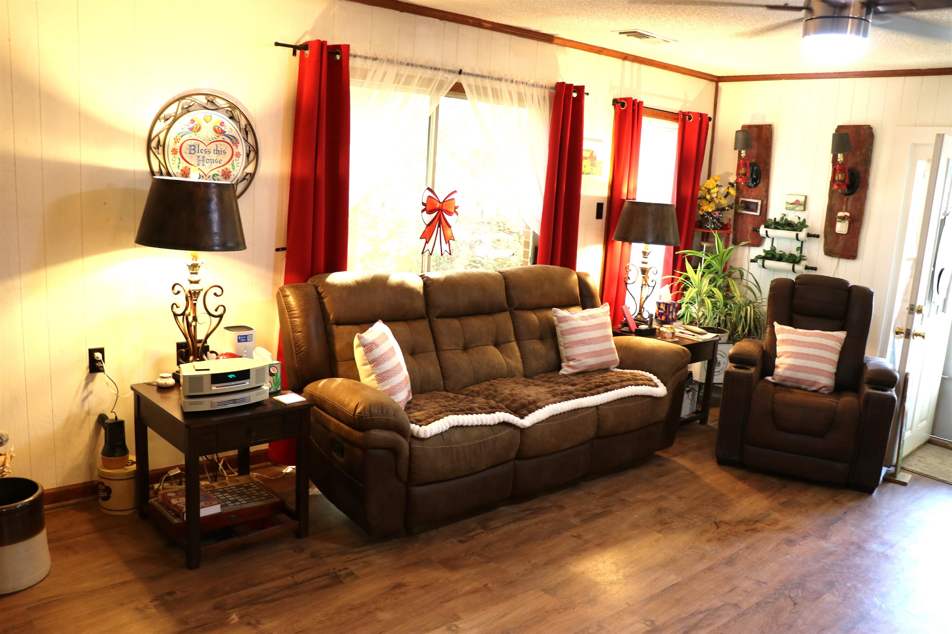 937 Kelleys Chapel Road Burlison, TN 38015 - Photo 9 of 27 Living area with wood finished floors, crown molding, wood walls, and a ceiling fan