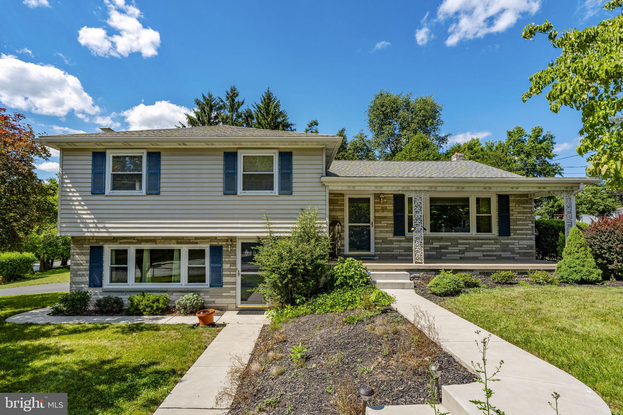 Charming split-level home with lush greenery.