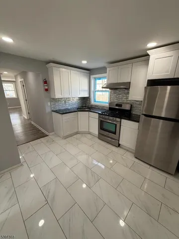 a large kitchen with cabinets and a stainless steel appliances