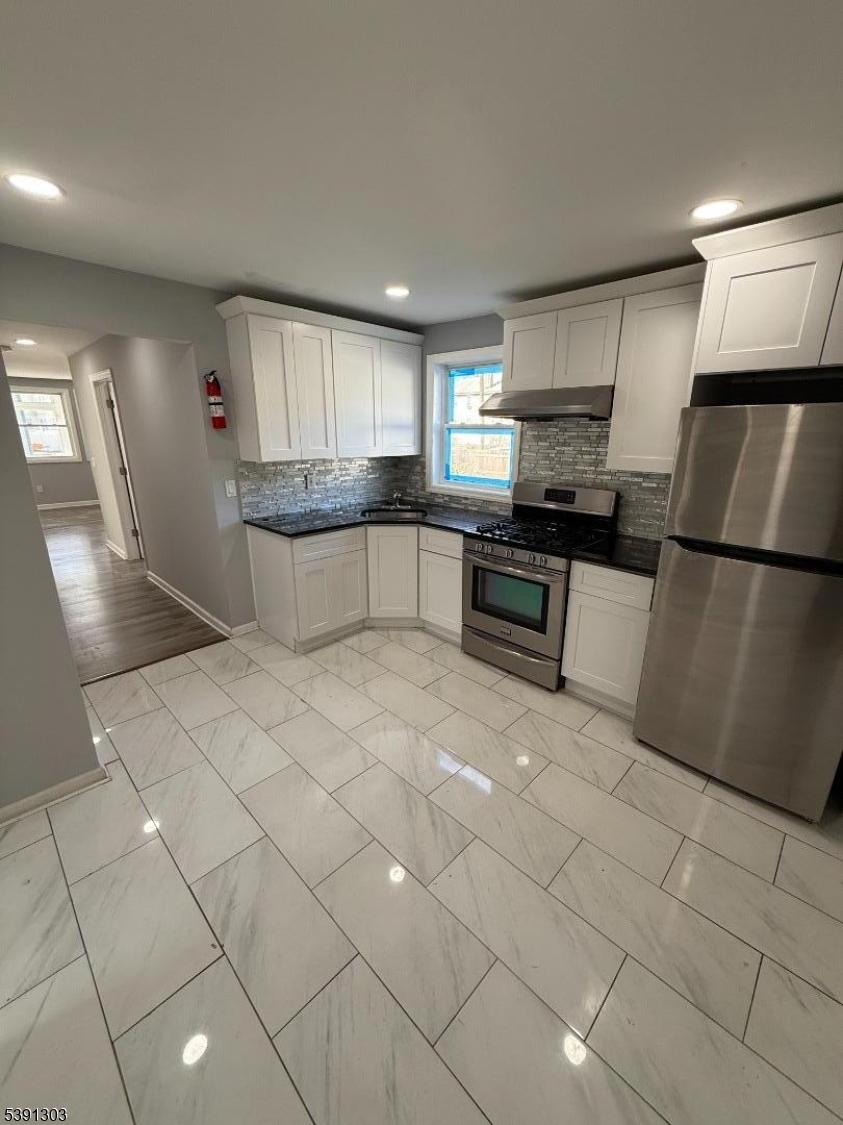 280 William Street, Unit A Rahway, NJ 07065 - Photo 15 of 26 a large kitchen with cabinets and a stainless steel appliances