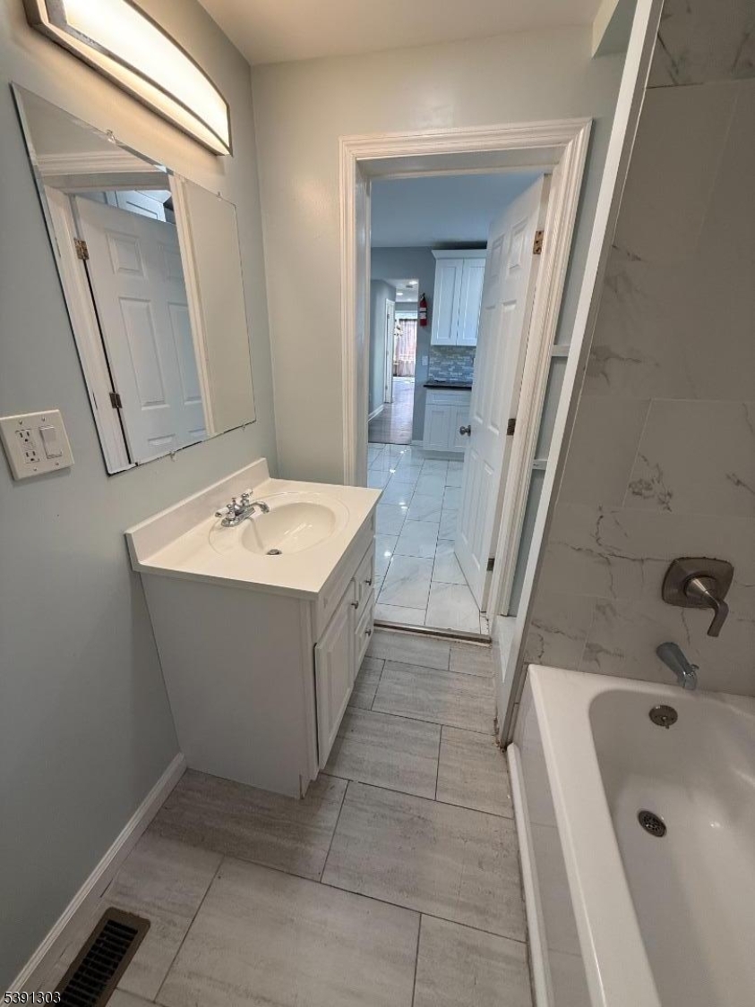 280 William Street, Unit A Rahway, NJ 07065 - Photo 16 of 26 a bathroom with a sink a bathtub and a mirror