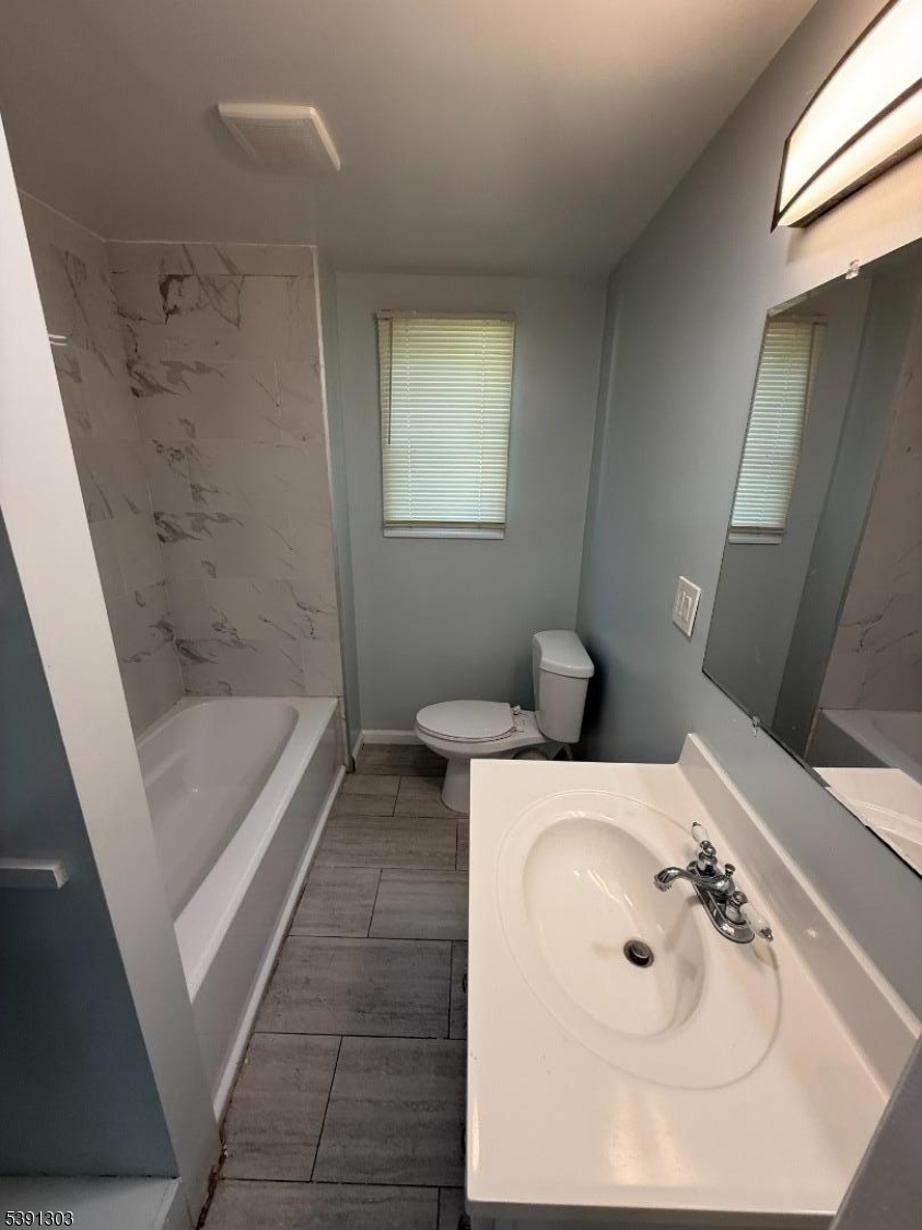 280 William Street, Unit A Rahway, NJ 07065 - Photo 19 of 26 a bathroom with a sink a toilet and shower