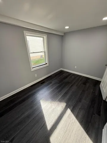 a view of an empty room and wooden floor