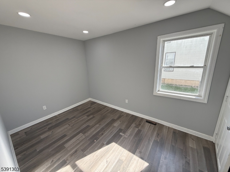 280 William Street, Unit A Rahway, NJ 07065 - Photo 2 of 26 an empty room with wooden floor and windows