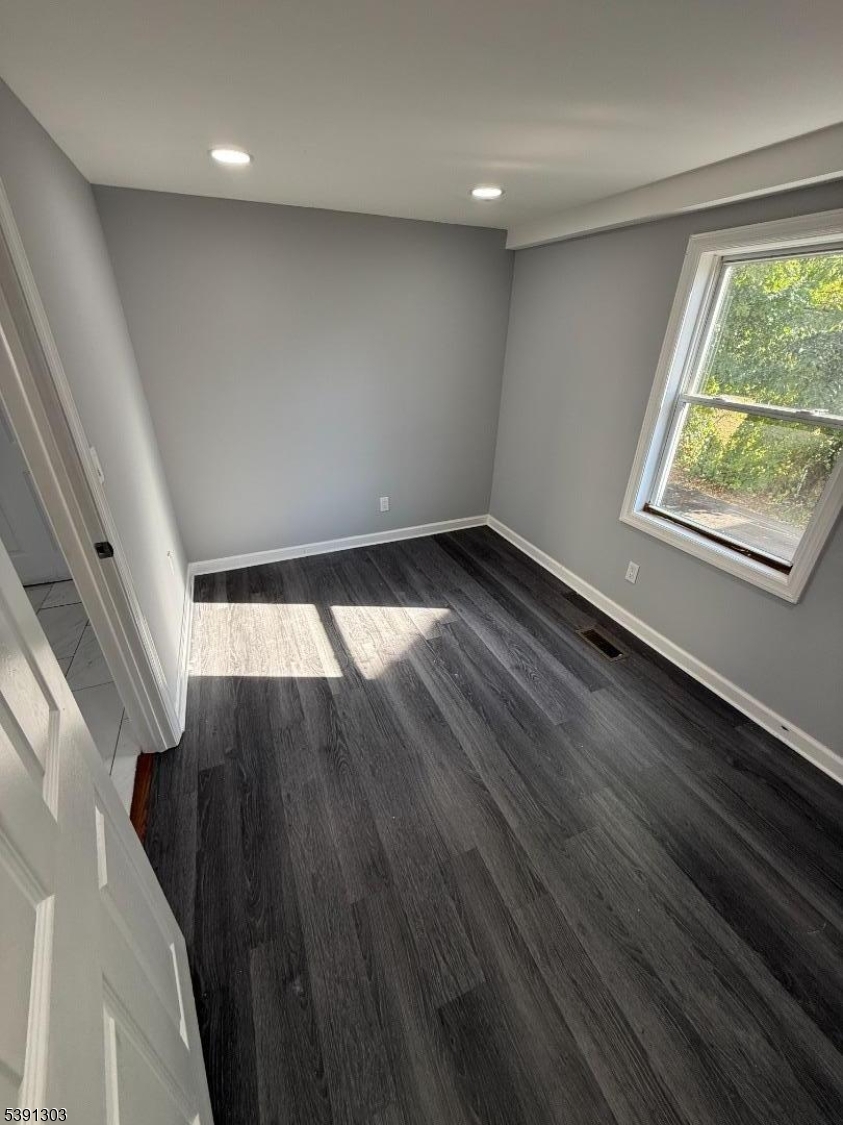 280 William Street, Unit A Rahway, NJ 07065 - Photo 21 of 26 an empty room with wooden floor and windows