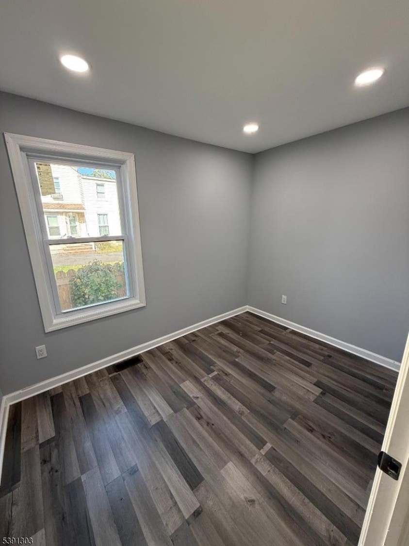 280 William Street, Unit A Rahway, NJ 07065 - Photo 24 of 26 an empty room with wooden floor and windows
