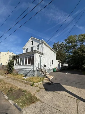 a view of a house with backyard and sitting area