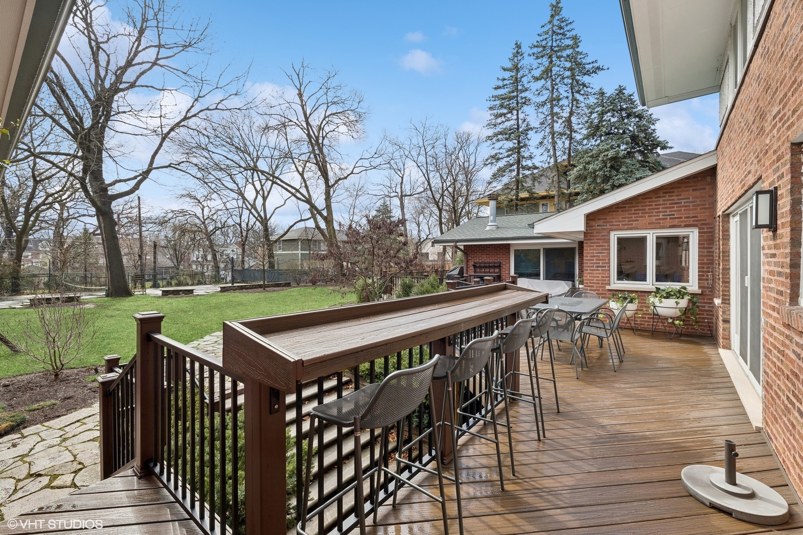 205 Bloomingbank Road Riverside, IL 60546 - Photo 42 of 46 a view of a patio with table and chairs with wooden floor and fence
