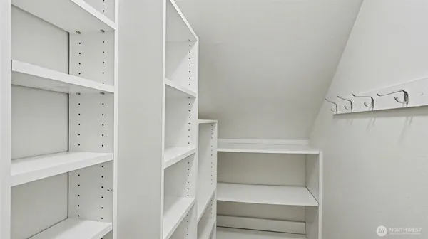 a view of walk in closet with white walls