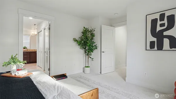 a bedroom with a bed and a potted plant