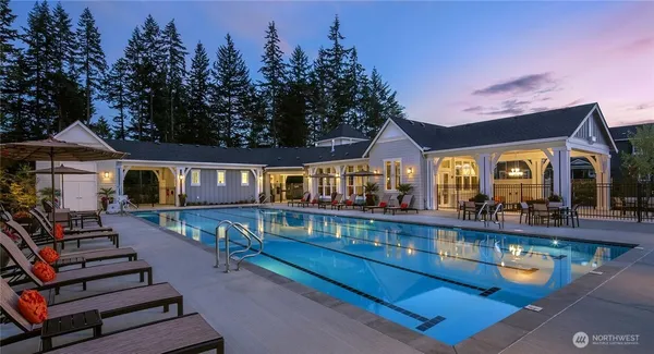 a view of a house with pool and chairs
