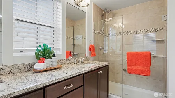 a bathroom with a granite countertop sink and a mirror