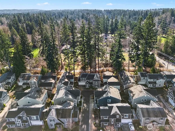 a aerial view of a house with large trees